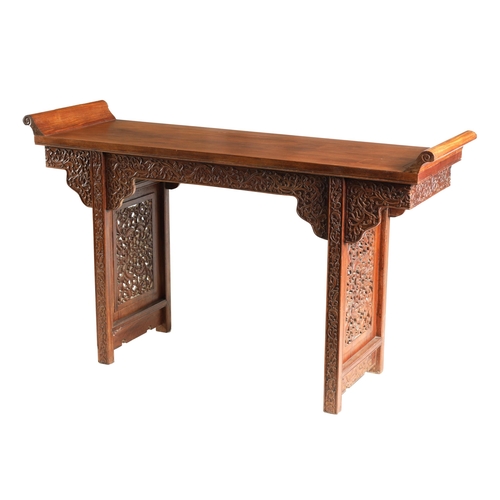 172 - A 19TH CENTURY CHINESE HARDWOOD ALTAR TABLE the top with raised sides above a shaped leaf carved fri... 