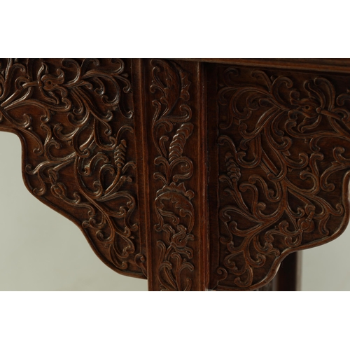 172 - A 19TH CENTURY CHINESE HARDWOOD ALTAR TABLE the top with raised sides above a shaped leaf carved fri... 