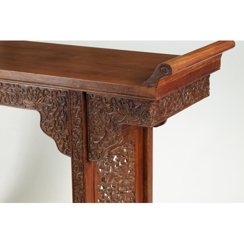 172 - A 19TH CENTURY CHINESE HARDWOOD ALTAR TABLE the top with raised sides above a shaped leaf carved fri... 