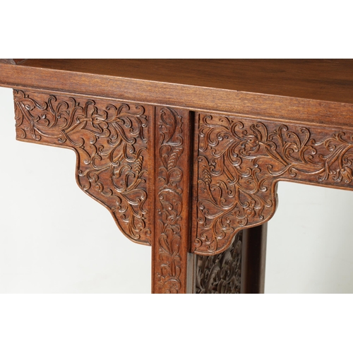 172 - A 19TH CENTURY CHINESE HARDWOOD ALTAR TABLE the top with raised sides above a shaped leaf carved fri... 