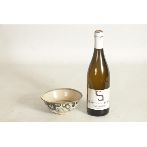 176 - A CHINESE MING SLIPWARE BOWL with blue scrollwork decoration on tapering foot (14.6cm diameter)