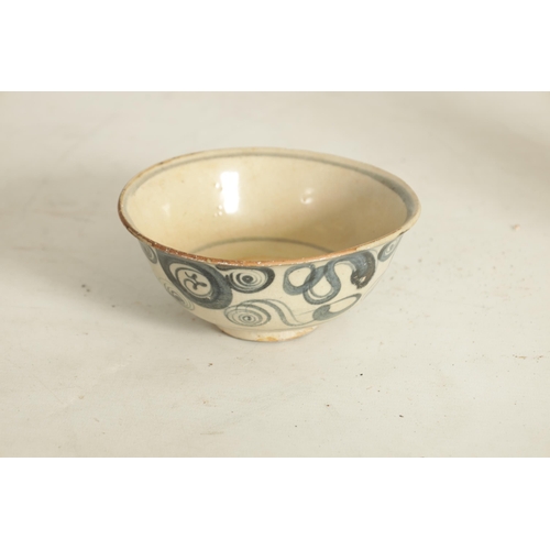 176 - A CHINESE MING SLIPWARE BOWL with blue scrollwork decoration on tapering foot (14.6cm diameter)