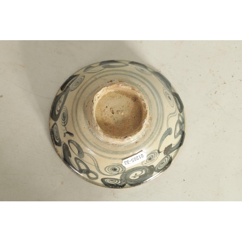 176 - A CHINESE MING SLIPWARE BOWL with blue scrollwork decoration on tapering foot (14.6cm diameter)