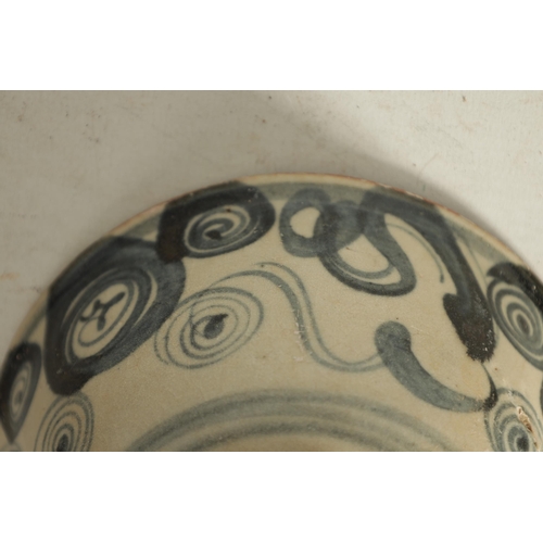 176 - A CHINESE MING SLIPWARE BOWL with blue scrollwork decoration on tapering foot (14.6cm diameter)