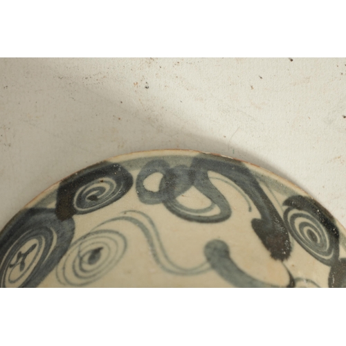 176 - A CHINESE MING SLIPWARE BOWL with blue scrollwork decoration on tapering foot (14.6cm diameter)