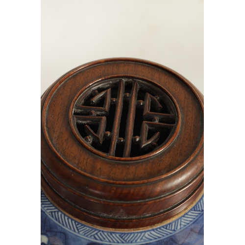 177 - AN EARLY CHINESE BLUE AND WHITE GINGER JAR WITH LATER HARDWOOD COVER of ovoid form, the body decorat... 