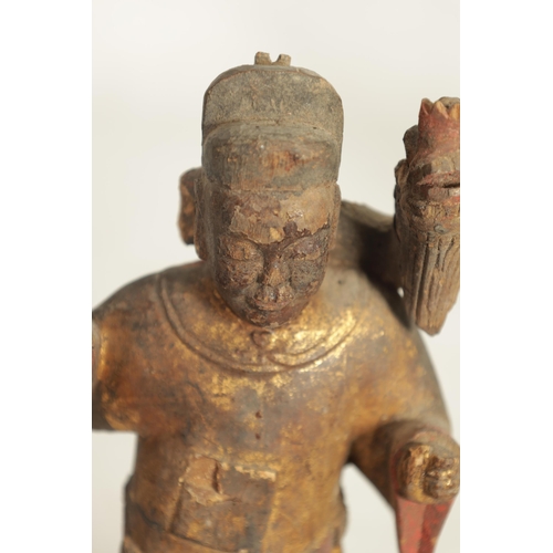 185 - A CHINESE MING PERIOD CARVED WOODEN FIGURE OF AN IMMORTAL with polychrome and gilt decoration. (24cm... 