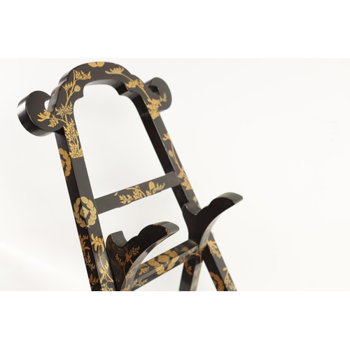 187 - A LATE EDO PERIOD JAPANESE LACQUERED FOLDING MIRROR STAND of easel form with scrolled top and decora... 