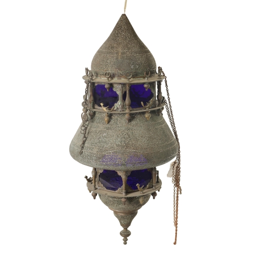 190 - A 19TH CENTURY EASTERN PIERCED BRASS HANGING LANTERN with blue glazed panels and Islamic-style case.... 