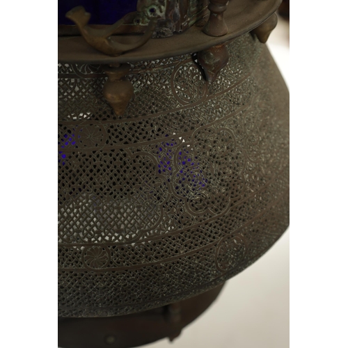 190 - A 19TH CENTURY EASTERN PIERCED BRASS HANGING LANTERN with blue glazed panels and Islamic-style case.... 