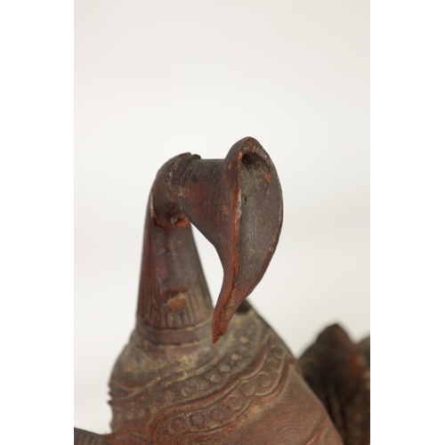 193 - AN EARLY 20TH CENTURY BURMESE CARVED HARDWOOD DANCING FIGURE mouted on a wavy edge base (68cm high )