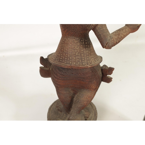 193 - AN EARLY 20TH CENTURY BURMESE CARVED HARDWOOD DANCING FIGURE mouted on a wavy edge base (68cm high )