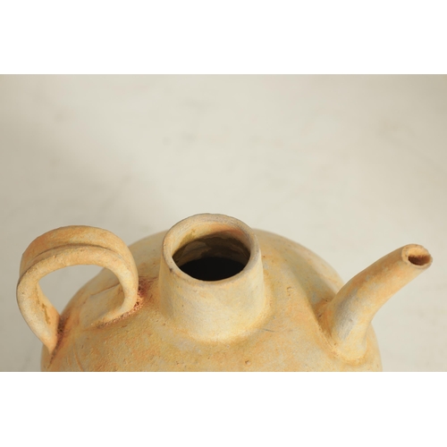 195 - A CHINESE TANG WINE EWER with bulbous gadrooned body and loop handle (14.5cm high)