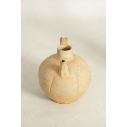 195 - A CHINESE TANG WINE EWER with bulbous gadrooned body and loop handle (14.5cm high)