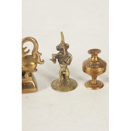 199 - AN ANTIQUE BRONZE BURMESE OPIUM WEIGHT together with various brass figures and objects (5) (Opium we... 