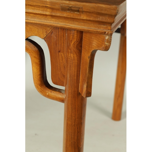 203 - A 20TH CENTURY CHINESE ELM CENTRE TABLE the cleated panelled figured top above a shaped all round cu... 