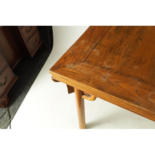 203 - A 20TH CENTURY CHINESE ELM CENTRE TABLE the cleated panelled figured top above a shaped all round cu... 