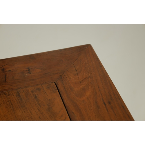 203 - A 20TH CENTURY CHINESE ELM CENTRE TABLE the cleated panelled figured top above a shaped all round cu... 