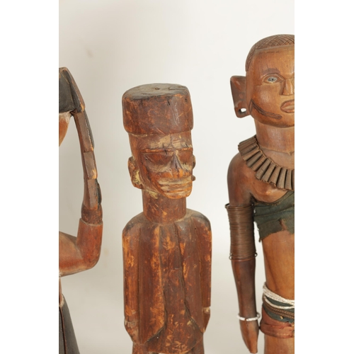 204 - A SELECTION OF SEVEN CARVED AFRICAN FIGURES of various size and design (50cm high and smaller )