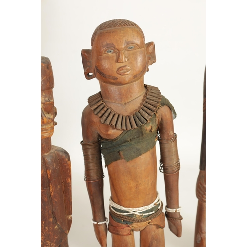 204 - A SELECTION OF SEVEN CARVED AFRICAN FIGURES of various size and design (50cm high and smaller )