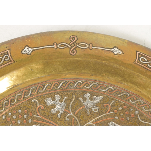 207 - A 19TH CENTURY ISLAMIC BRASS AND MIXED METAL CHARGER with birds in branch work (32.5cm diameter )