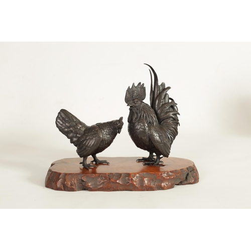 209 - A JAPANESE MEIJI PATINATED BRONZE SCULPTURE ON HARDWOOD BASE finely modelled as a cockerel and hen s... 