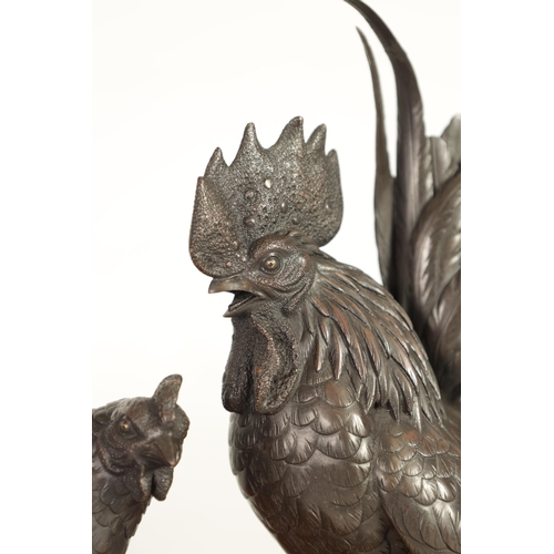 209 - A JAPANESE MEIJI PATINATED BRONZE SCULPTURE ON HARDWOOD BASE finely modelled as a cockerel and hen s... 