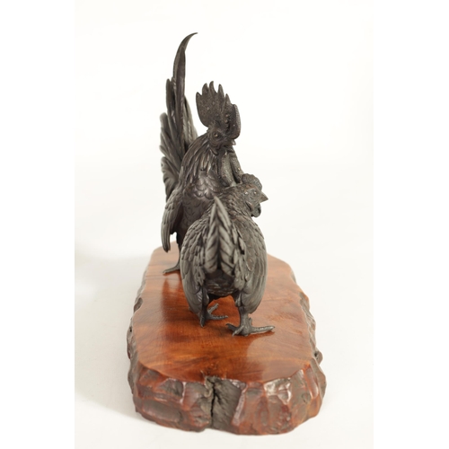 209 - A JAPANESE MEIJI PATINATED BRONZE SCULPTURE ON HARDWOOD BASE finely modelled as a cockerel and hen s... 