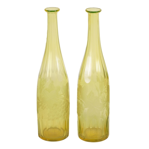 21 - A PAIR OF BOHEMIAN PALE AMBER WINE BOTTLES with faceted tapered slender necks and lower bodies enclo... 