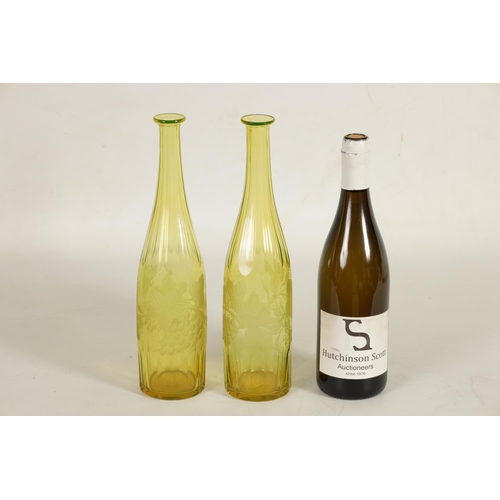 21 - A PAIR OF BOHEMIAN PALE AMBER WINE BOTTLES with faceted tapered slender necks and lower bodies enclo... 