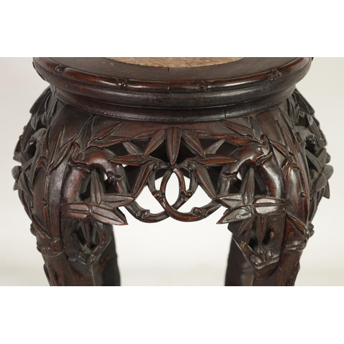 210 - A SMALL 19TH CENTURY CHINESE CARVED HARDWOOD JARDINIERE STAND the pink circular marble inset top abo... 