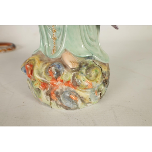 215 - A 19TH CENTURY CHINESE PORCELAIN GUAN YIN STATUE decorated with polychrome colours, on a naturalisti... 