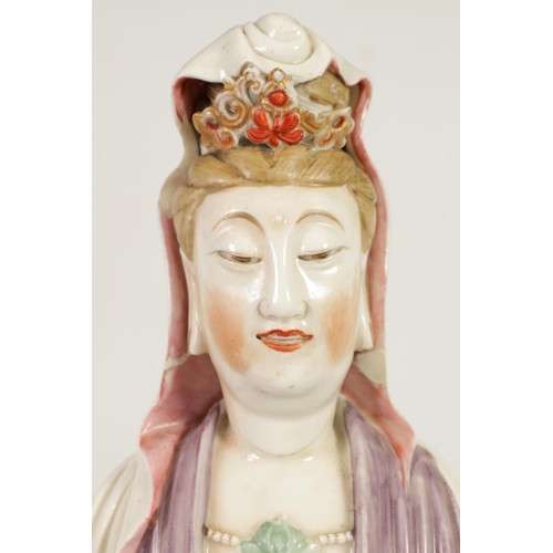 215 - A 19TH CENTURY CHINESE PORCELAIN GUAN YIN STATUE decorated with polychrome colours, on a naturalisti... 