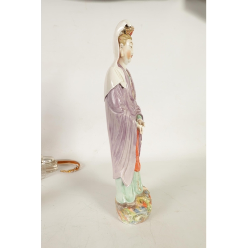 215 - A 19TH CENTURY CHINESE PORCELAIN GUAN YIN STATUE decorated with polychrome colours, on a naturalisti... 