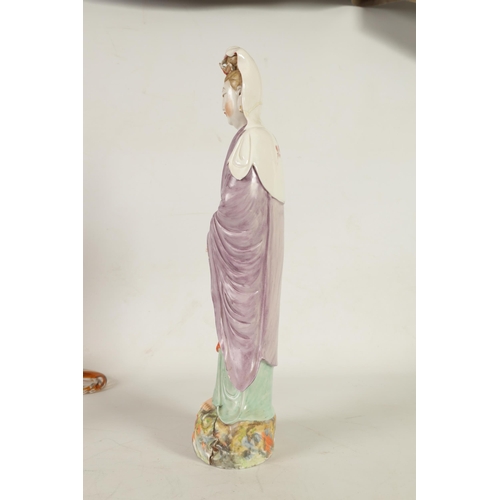 215 - A 19TH CENTURY CHINESE PORCELAIN GUAN YIN STATUE decorated with polychrome colours, on a naturalisti... 