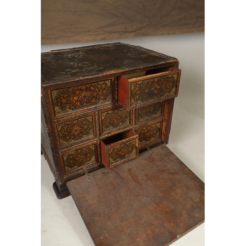 216 - A 17TH CENTURY ANGLO INDIAN TABLE CABINET with scroll and portrait decorated painted body; the hinge... 