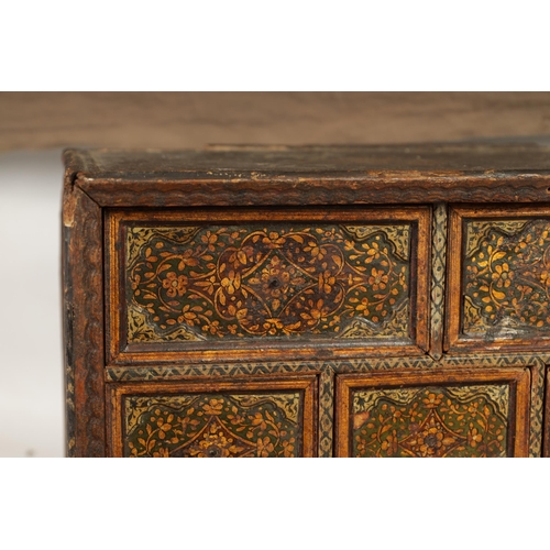 216 - A 17TH CENTURY ANGLO INDIAN TABLE CABINET with scroll and portrait decorated painted body; the hinge... 