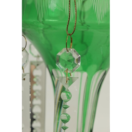 22 - A PAIR OF 19TH CENTURY GREEN AND CLEAR GLASS LUSTRES with facet cut tapering bodies and angled dropp... 