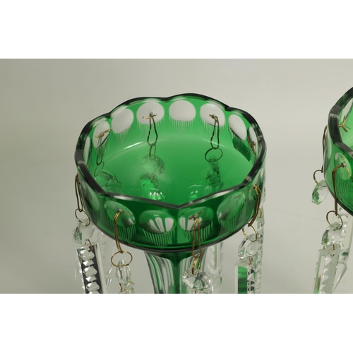 22 - A PAIR OF 19TH CENTURY GREEN AND CLEAR GLASS LUSTRES with facet cut tapering bodies and angled dropp... 