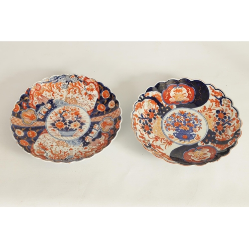 221 - TWO 19TH CENTURY JAPANESE IMARI PORCELAIN CHARGERS of floral panelled design with scalloped edges (2... 