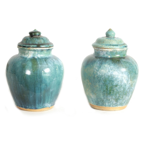 222 - A PAIR OF CHINESE NORTHERN SONG GLAZED VASE AND COVERS having domed lids and bulbous tapering bodies... 