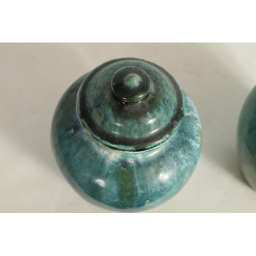 222 - A PAIR OF CHINESE NORTHERN SONG GLAZED VASE AND COVERS having domed lids and bulbous tapering bodies... 