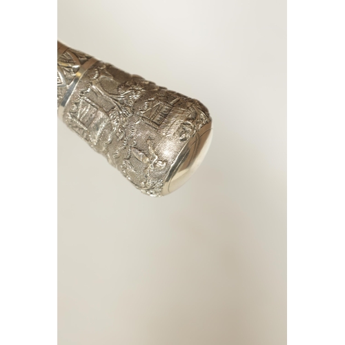 223 - A 19TH CENTURY CHINESE SILVER TOPPED WALKING CANE the handle depicting figures in a village scene on... 