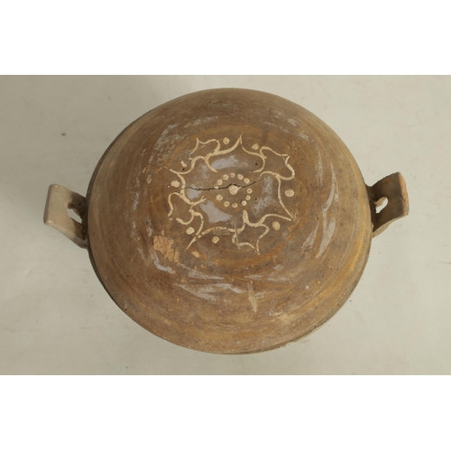 230 - A CHINESE TANG PERIOD THREE LEGGED POT AND COVER the domed lid with painted flowerhead on a two hand... 