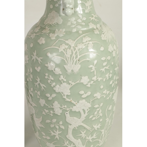 237 - A LARGE 19TH CENTURY CHINESE RELIEF DECORATED CELADON VASE with a scalloped rim and foo dog side han... 