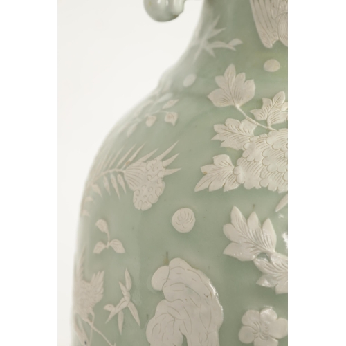 237 - A LARGE 19TH CENTURY CHINESE RELIEF DECORATED CELADON VASE with a scalloped rim and foo dog side han... 