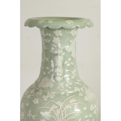 237 - A LARGE 19TH CENTURY CHINESE RELIEF DECORATED CELADON VASE with a scalloped rim and foo dog side han... 