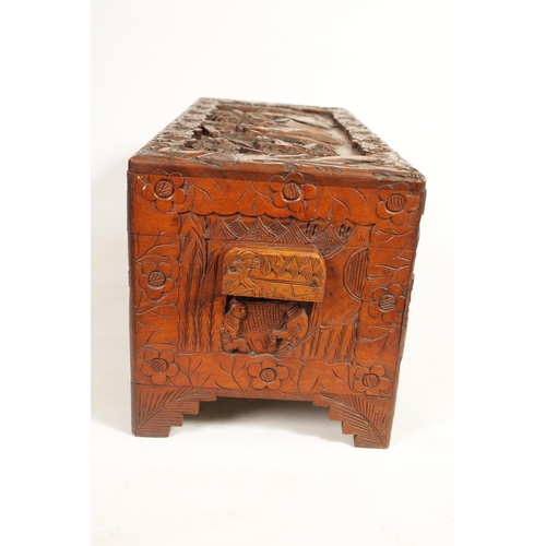 239 - AN EARLY 20TH CENTURY CHINESE CARVED HARDWOOD BLANKET BOX with carved figural landscape panels to th... 