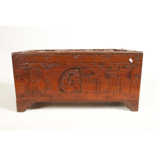 239 - AN EARLY 20TH CENTURY CHINESE CARVED HARDWOOD BLANKET BOX with carved figural landscape panels to th... 