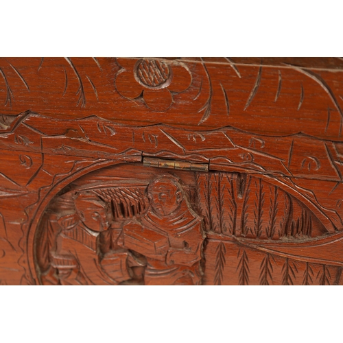 239 - AN EARLY 20TH CENTURY CHINESE CARVED HARDWOOD BLANKET BOX with carved figural landscape panels to th... 